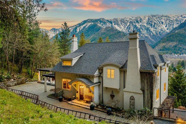 an aerial view of a house with a yard and balcony