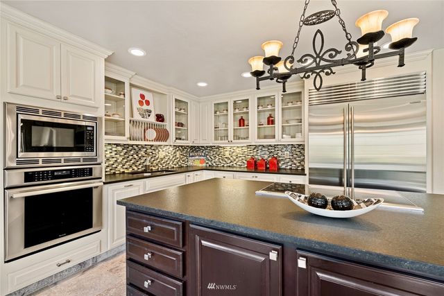 a kitchen with a sink and chandelier