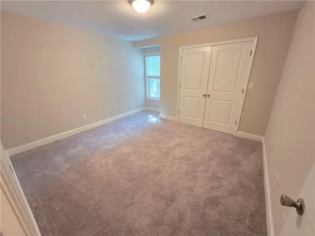 an empty room with closet area