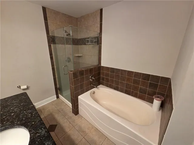 a bathroom with a bathtub and a shower