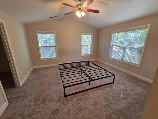 a view of a livingroom with a ceiling fan and window