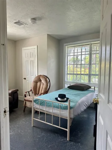 a bedroom with bed and a window