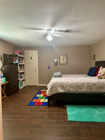 a bedroom with bed and a view of bedroom