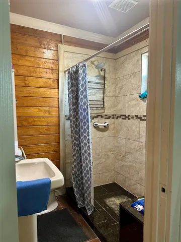 a bathroom with a shower and a sink