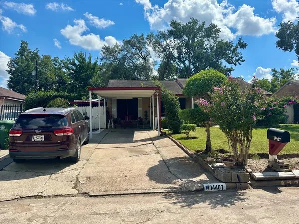 a view of a patio with table and chairs and a barbeque