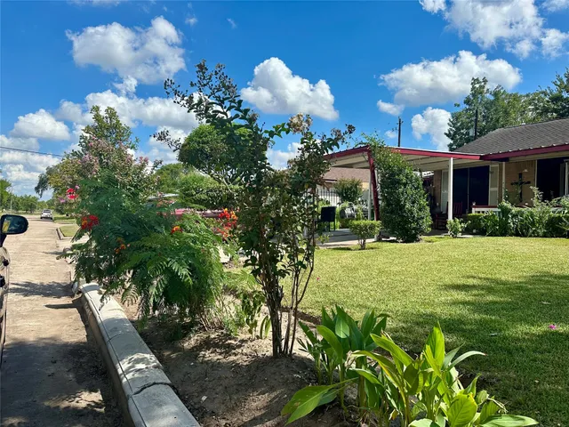 a view of a house with a yard and garden