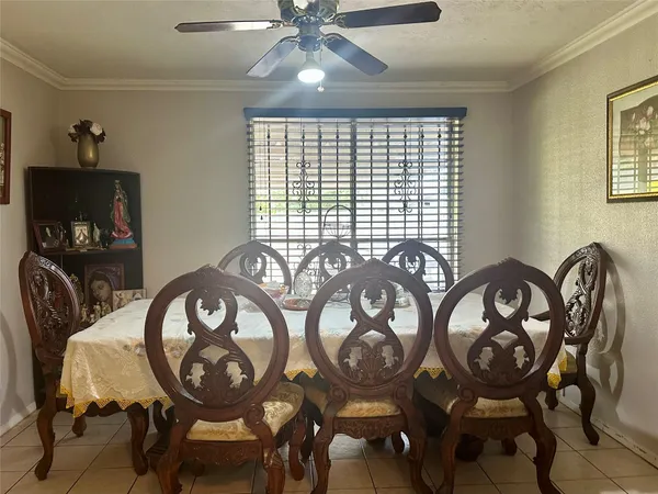 a view of a dining room with furniture and chandelier