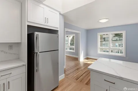 a kitchen with stainless steel appliances a refrigerator sink and cabinets