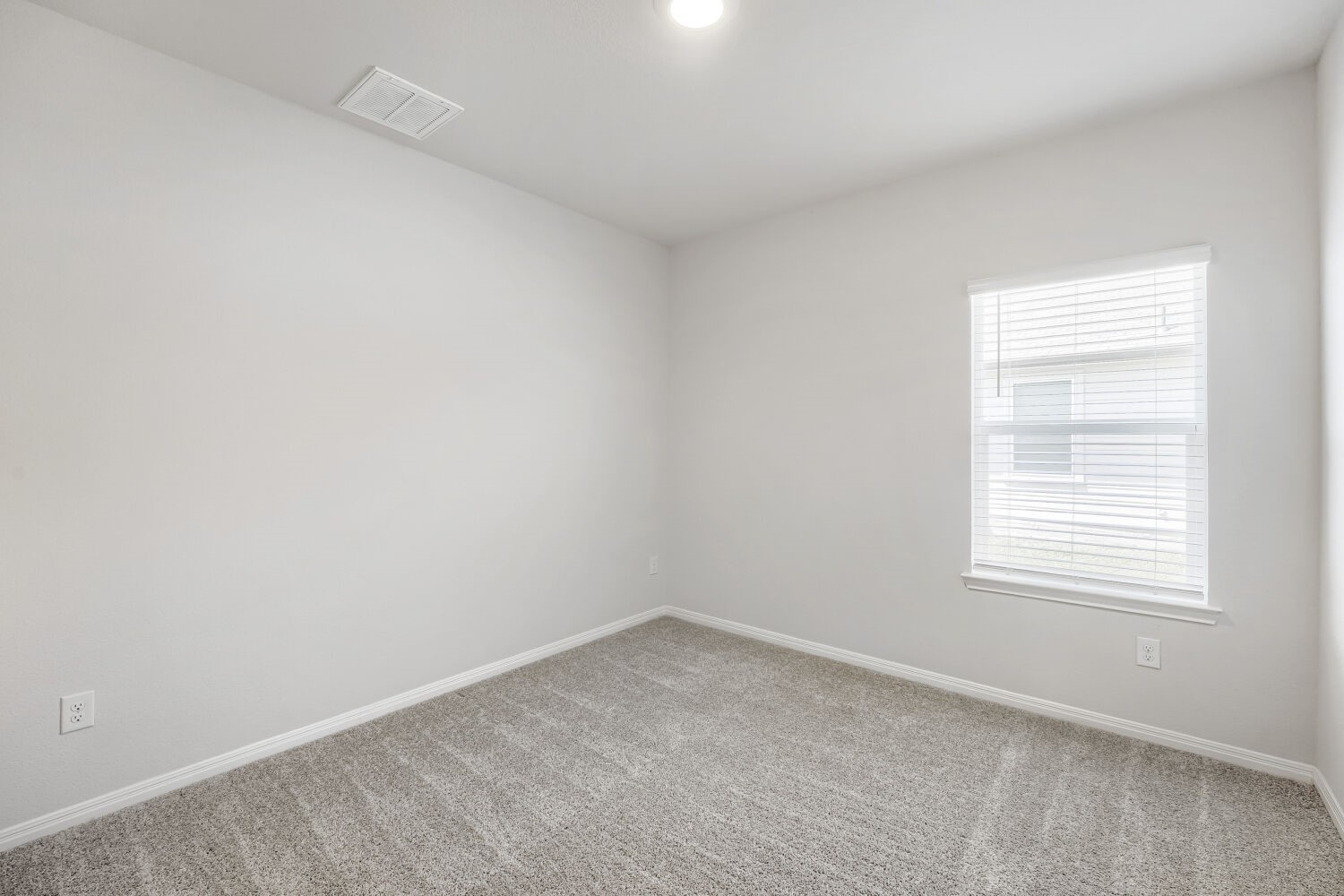 13507 Howser Trace Manor, TX 78653 - Photo 17 of 28 A well-lit bedroom featuring soft carpet flooring and a single window.