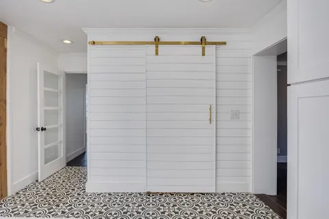 a view of a livingroom with wooden floor and a fireplace