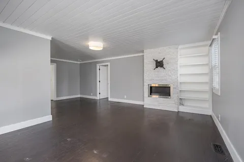 a bedroom with a bed lamp and a window