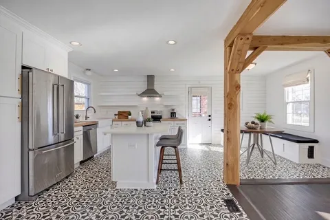 a kitchen with stainless steel appliances a sink stove and cabinets