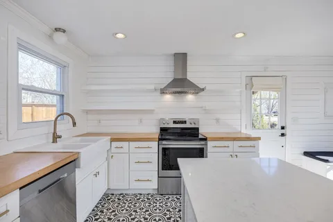 a bathroom with a sink a toilet and large mirror