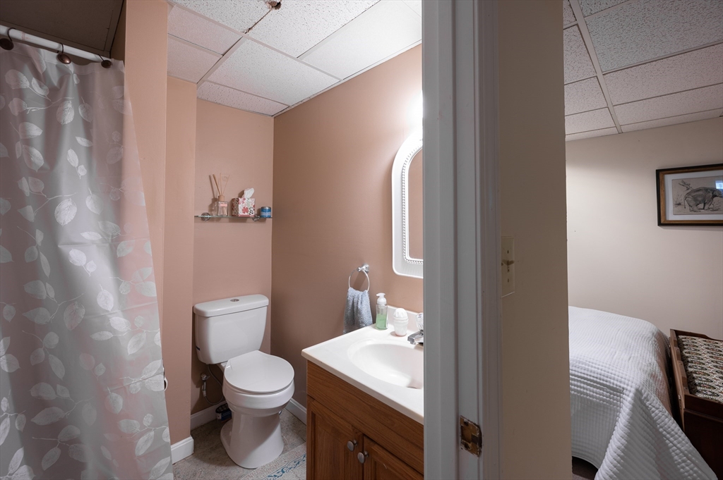 29 Wituwamat Road Weymouth, MA 02191 - Photo 33 of 42 a white toilet sitting next to a bathroom sink and vanity