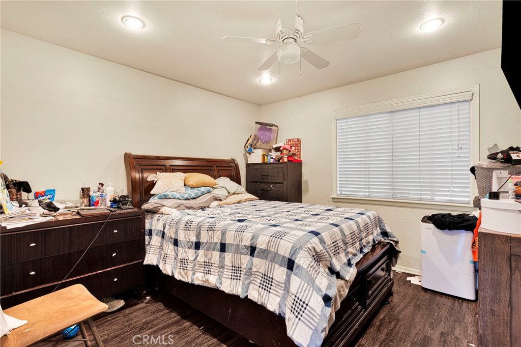 1087 Baseline Road La Verne, CA 91750 - Photo 27 of 39 a bedroom with a bed and wooden floor