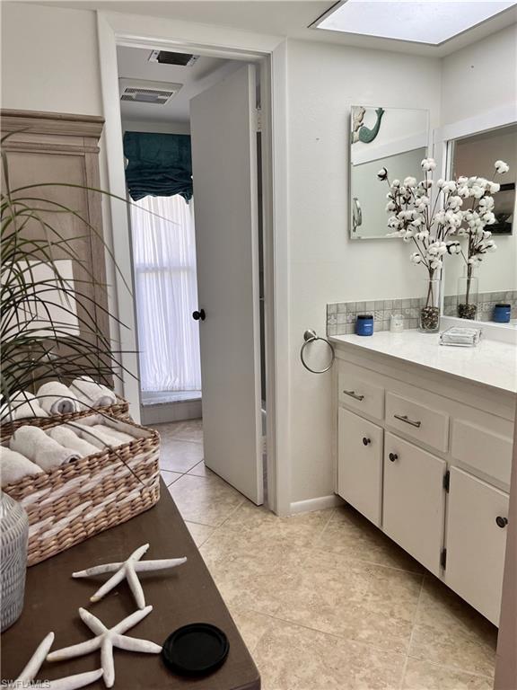 348 Tern Drive, Unit 4 Naples, FL 34112 - Photo 11 of 26 a spacious bathroom with a sink and a mirror