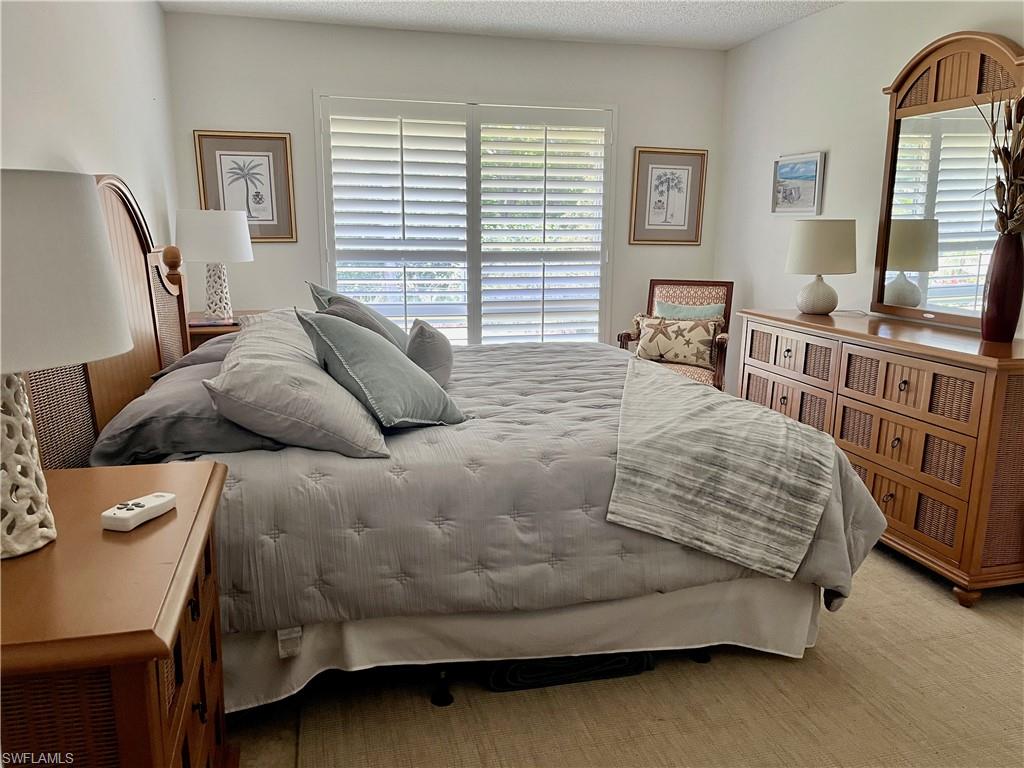 348 Tern Drive, Unit 4 Naples, FL 34112 - Photo 12 of 26 a bedroom with a bed and window