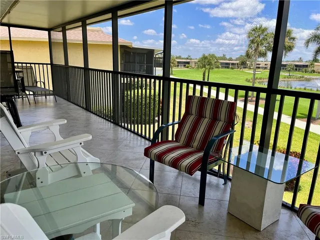 a view of a chairs and table in the balcony