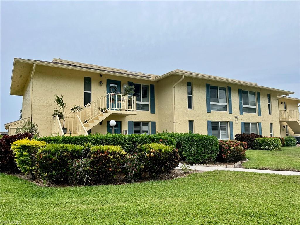 348 Tern Drive, Unit 4 Naples, FL 34112 - Photo 2 of 26 a front view of a house with a yard