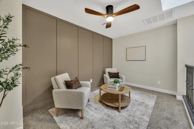a living room with furniture and a potted plant