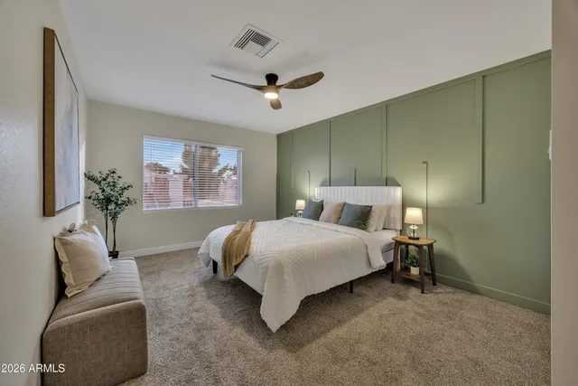 a bedroom with a large bed and a couch