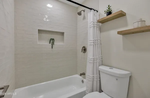 a bathroom with a toilet and shower