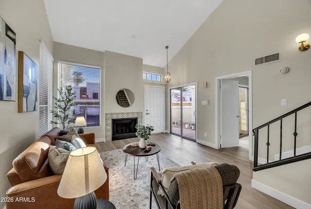 a living room with furniture rug and a fireplace