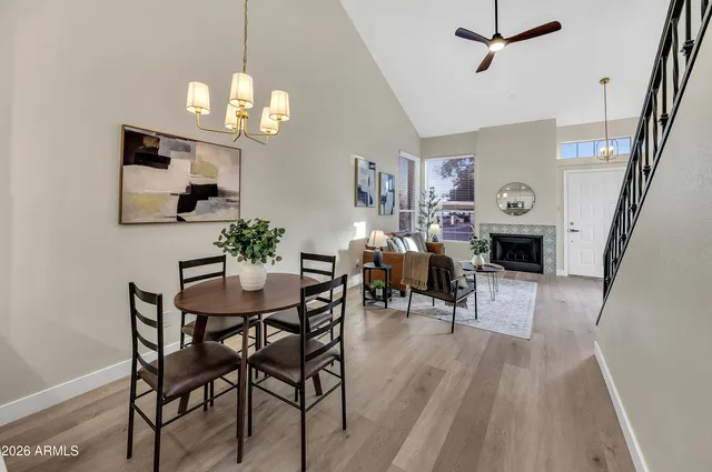 a view of a dining room with furniture a chandelier and wooden floor