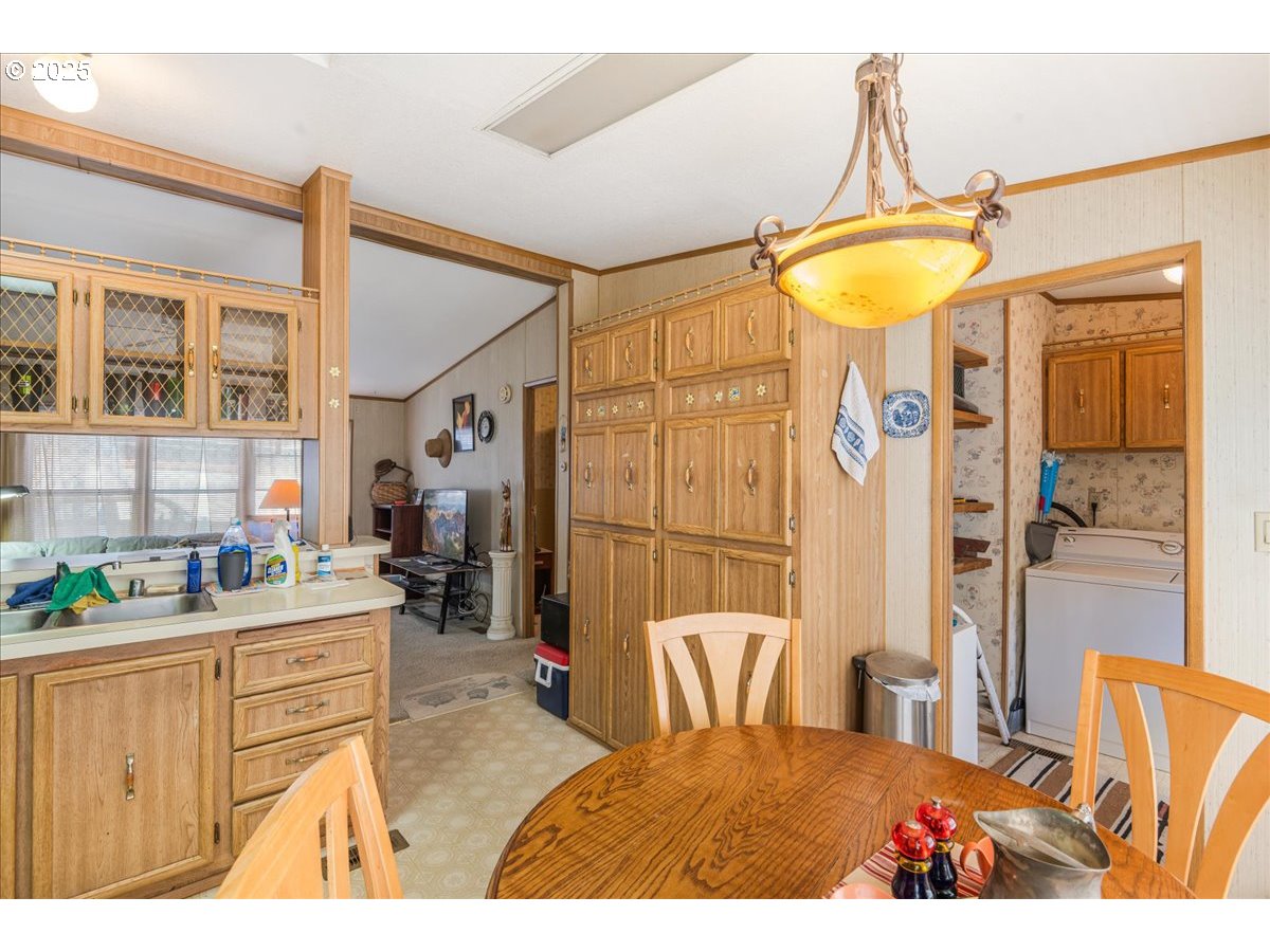 300 Southwest 7th Avenue, Unit 302 Battle Ground, WA 98604 - Photo 13 of 41 a living room with a couch and chandelier