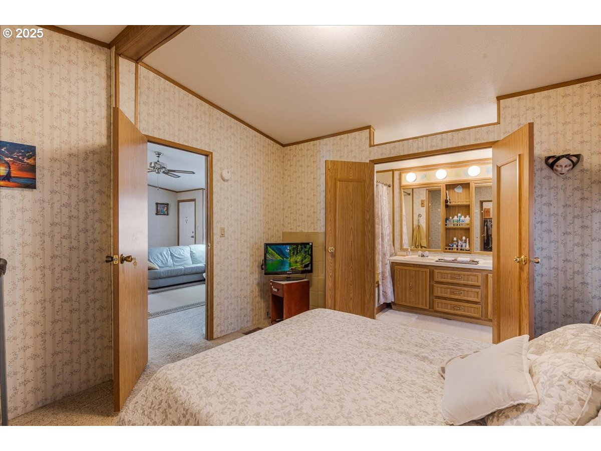 300 Southwest 7th Avenue, Unit 302 Battle Ground, WA 98604 - Photo 16 of 41 a bedroom with a bed and dresser with mirror
