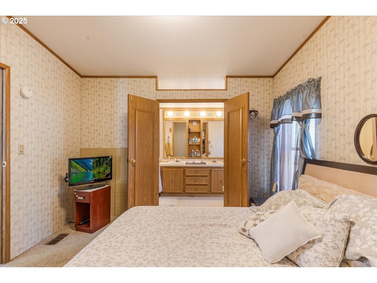 300 Southwest 7th Avenue, Unit 302 Battle Ground, WA 98604 - Photo 17 of 41 a bedroom with a bed and a large window