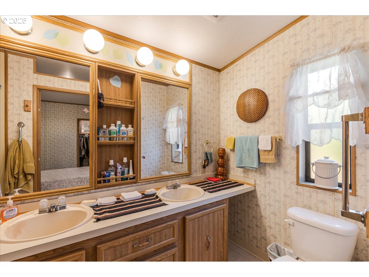 300 Southwest 7th Avenue, Unit 302 Battle Ground, WA 98604 - Photo 18 of 41 a bathroom with a sink double vanity and a mirror