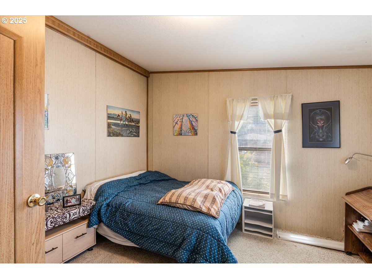 300 Southwest 7th Avenue, Unit 302 Battle Ground, WA 98604 - Photo 20 of 41 a bedroom with a bed and a dresser