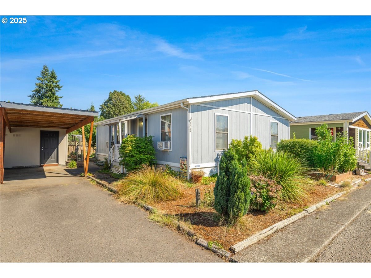 300 Southwest 7th Avenue, Unit 302 Battle Ground, WA 98604 - Photo 2 of 41 a view of a house with backyard and sitting area