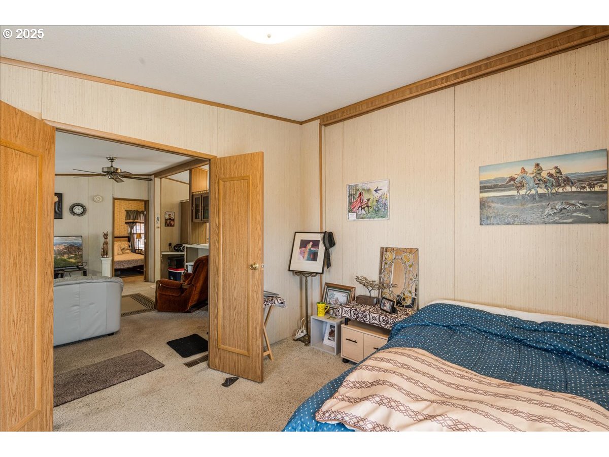 300 Southwest 7th Avenue, Unit 302 Battle Ground, WA 98604 - Photo 21 of 41 a bedroom with a bed and wooden floor
