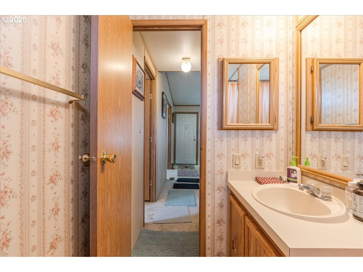 300 Southwest 7th Avenue, Unit 302 Battle Ground, WA 98604 - Photo 23 of 41 a bathroom with a sink double vanity and a mirror
