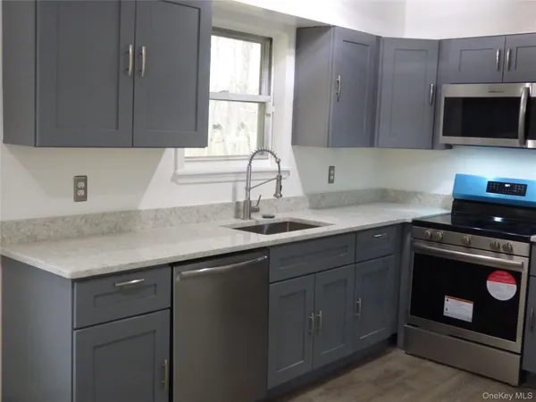 a kitchen with a sink stove and microwave