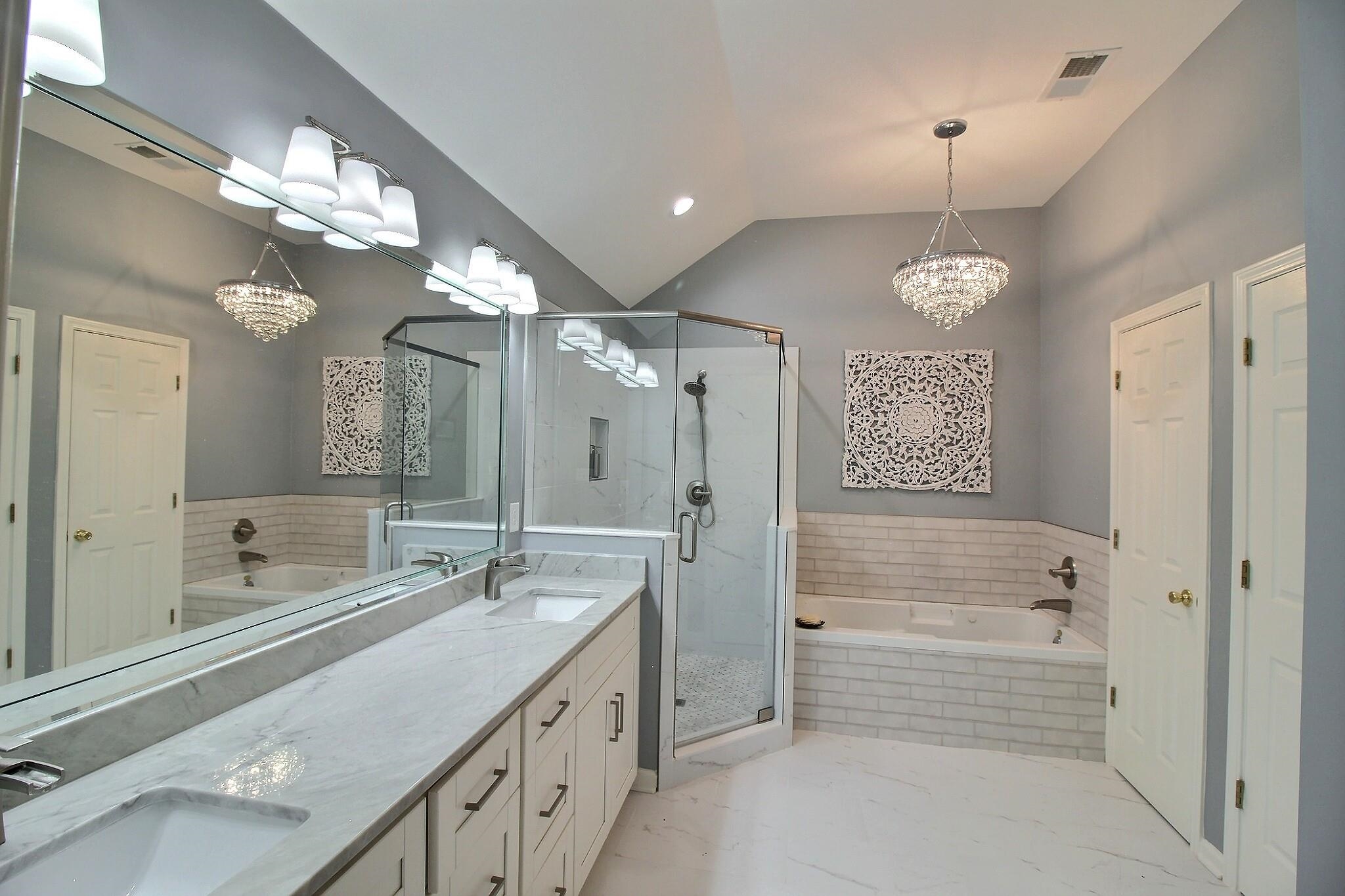 4530 Park Ridge Parkway Collierville, TN 38017 - Photo 17 of 27 a spacious bathroom with a shower a sink and a large mirror