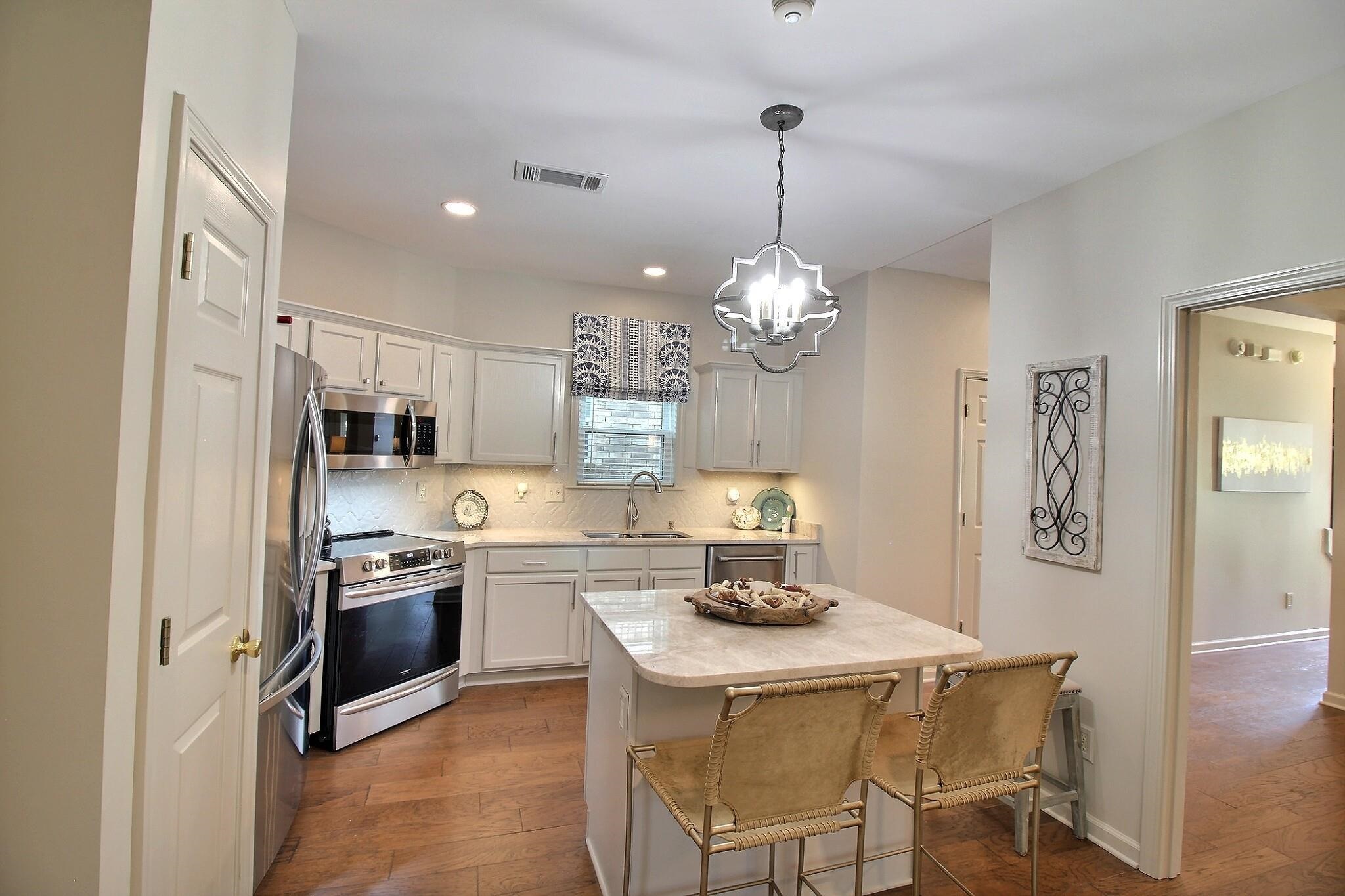 4530 Park Ridge Parkway Collierville, TN 38017 - Photo 8 of 27 a kitchen with stainless steel appliances kitchen island granite countertop a sink and refrigerator
