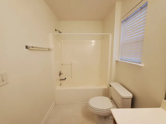 a bathroom with a toilet and shower