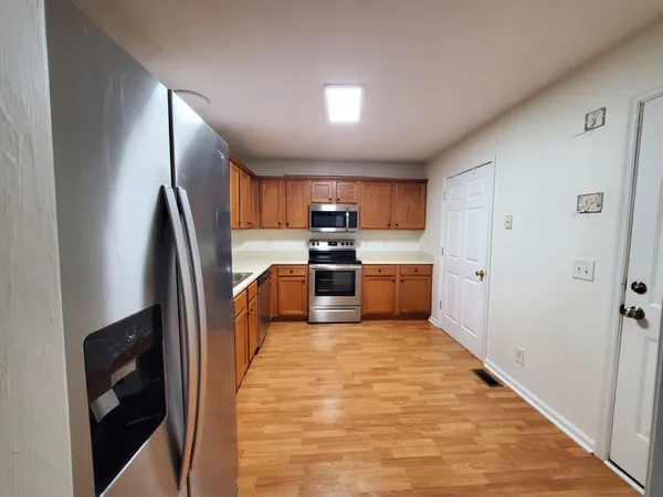 a kitchen with stainless steel appliances granite countertop a refrigerator and a sink