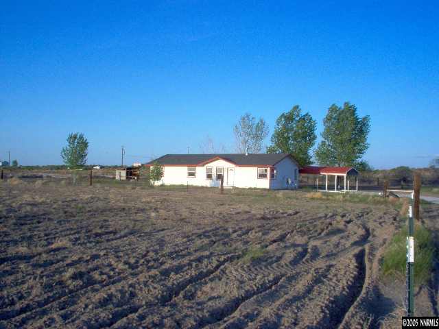4000 Lone Tree Road Fallon, NV 89406 - Photo 1 of 8 a front view of a house with a yard