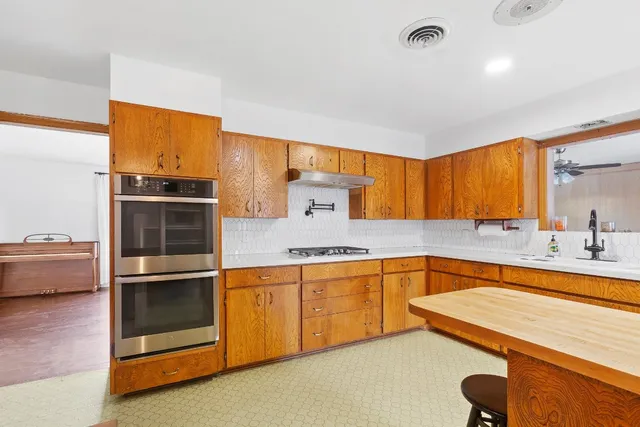 a kitchen with stainless steel appliances granite countertop a sink and cabinets