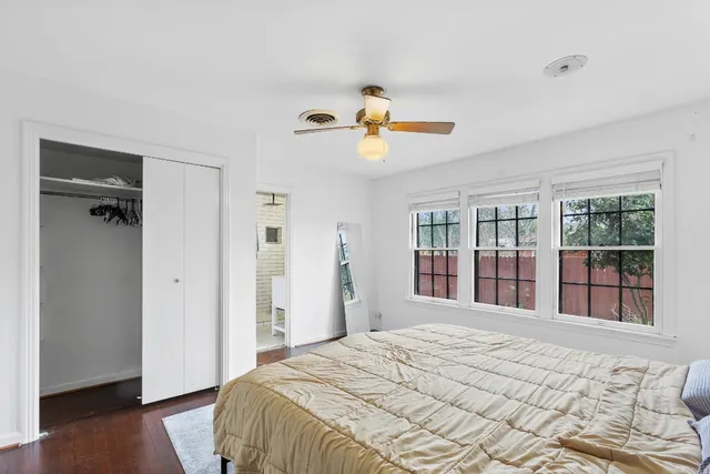 a bedroom with a large bed and a window