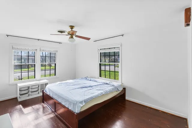 a living room with a bed furniture and a window