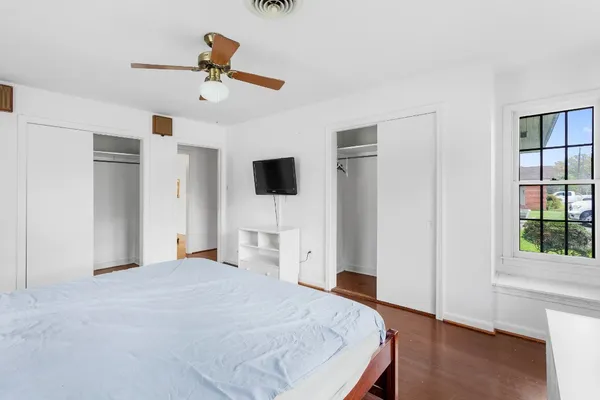 a bedroom with a bed and a view of kitchen