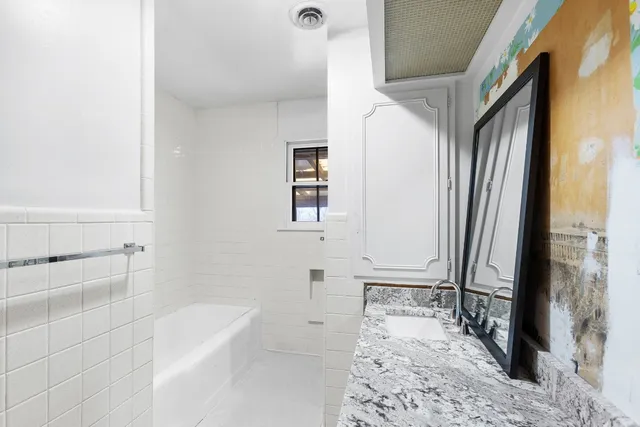 a bathroom with a bathtub and shower