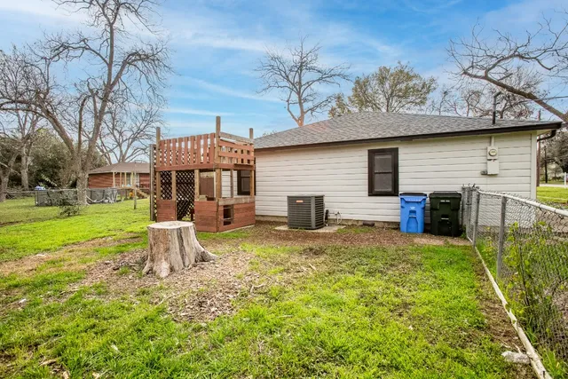 a view of a house with a yard patio and fire pit