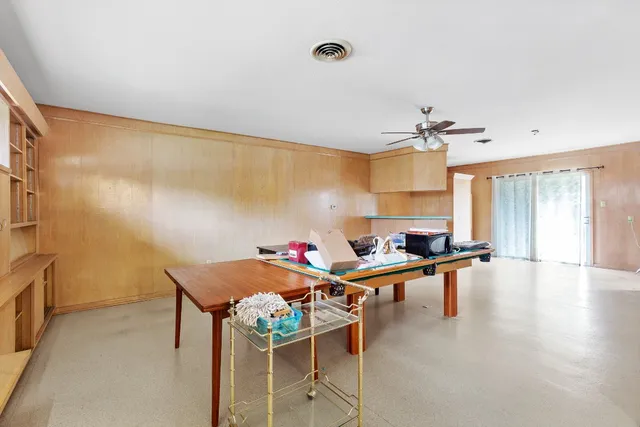 a living room with furniture a dining table and a fireplace