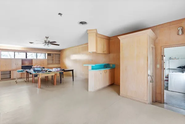 a view of a dining room with furniture and a kitchen